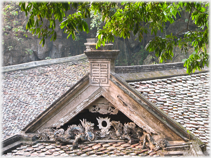 Dragons writhing in the eves of a roof.