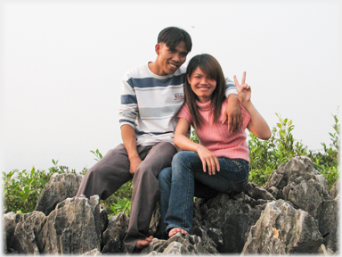 Young couple of visitors saying 'Hi' to the camera.