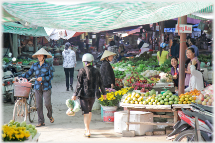 Market entrance lined with fruit stalls.
