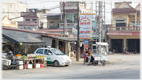 Corner of AH1 and main shopping street, with taxi parked.