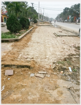 Side area of the road beginning to be  dug up.