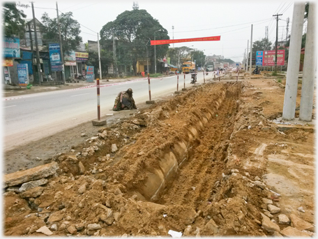 Side area of the road with a new road drain being dug out.