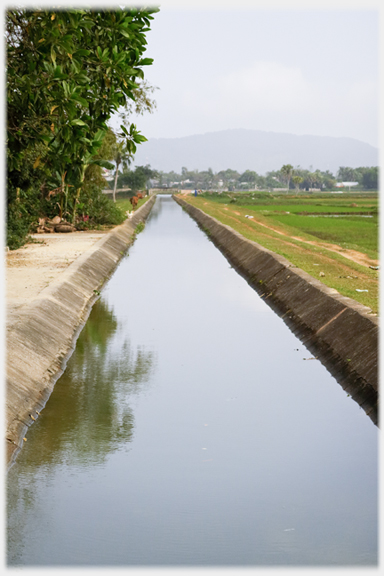 Long straight water channel fairly full.