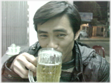 Man taking a drink from a glass of beer.