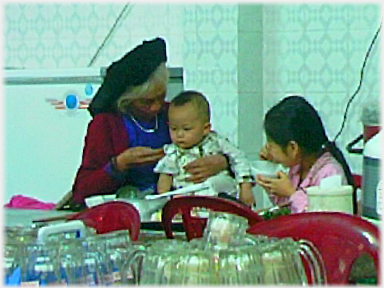 Grandmother feeding great-grand-child.