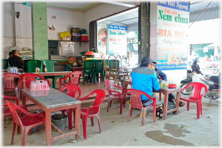 Two men sitting at one of the outside tables.