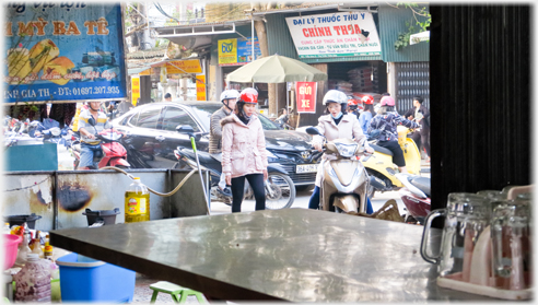 Looking over a table out onto the street.