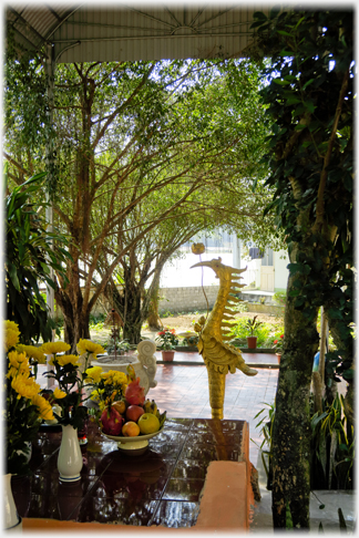 Crane and flowers framed with trees.