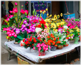 Plastic flowers at the side entrance.