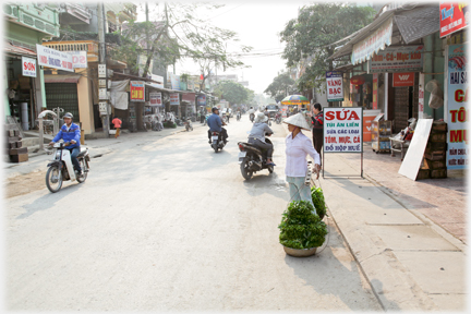 The woman of the last picture in the context of the street.