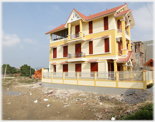 Large modern oche coloured house.