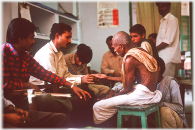 Examining a patient's hand.