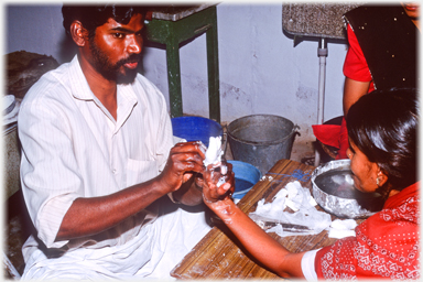 Putting plaster on a woman's fingers.