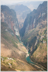 Huge vertical cleft with river.