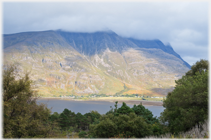 The view of the hill across the loch in cooler light.