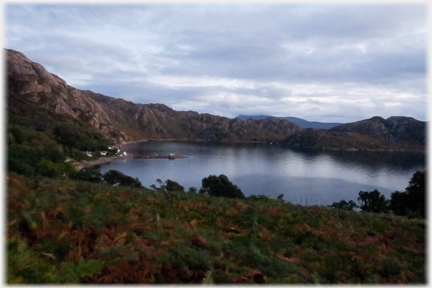 Cliffs surround bay in last light.