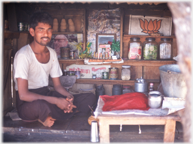 Man in kiosk shop.