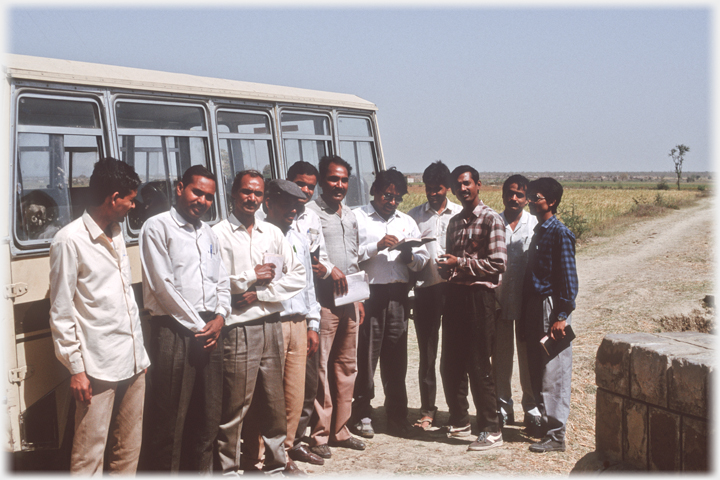 Team beside the bus.