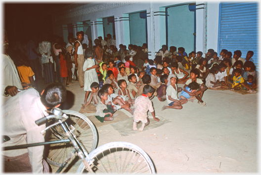 Children sitting waiting for film.