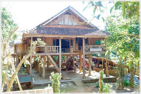 Thai house with verandas and tiled roof.