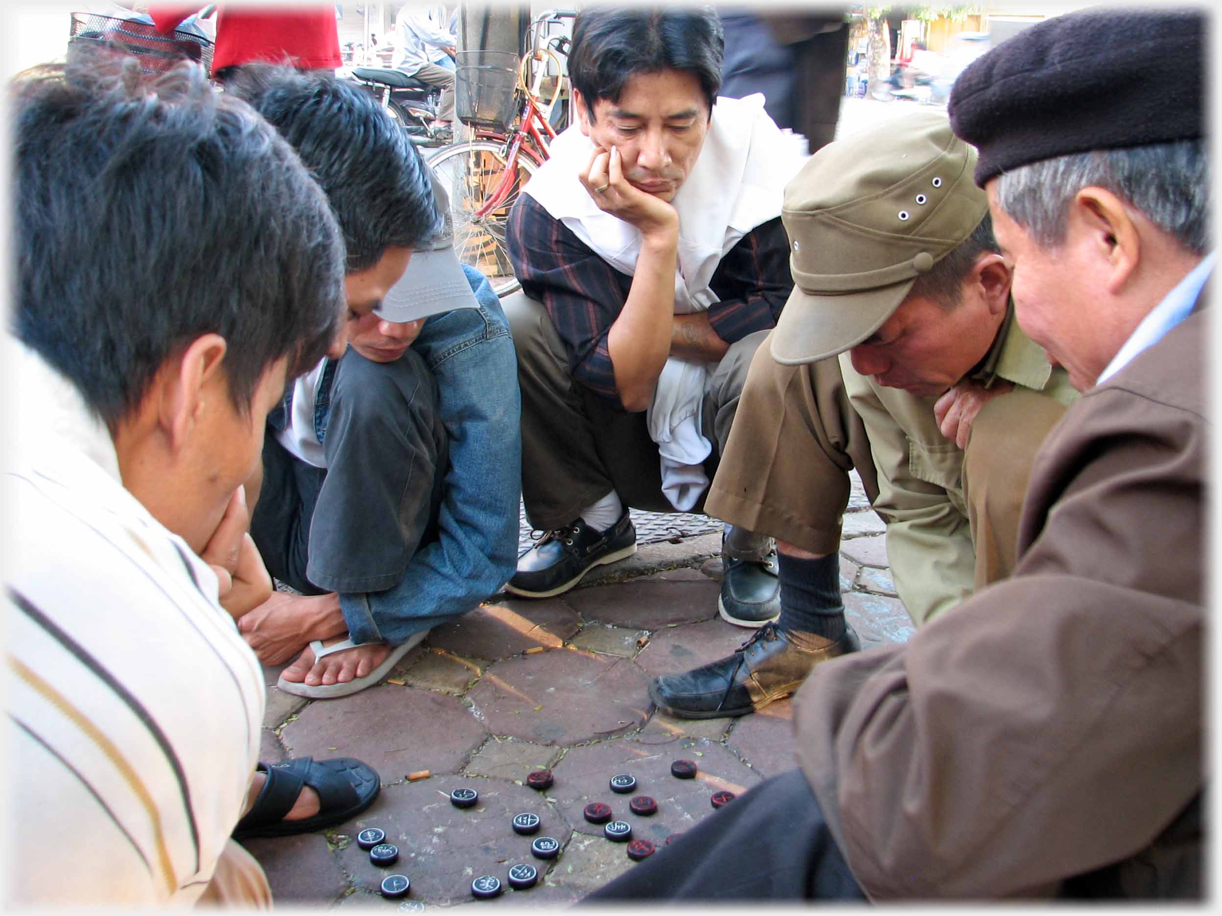 Six hunkered men intent on game with no board.