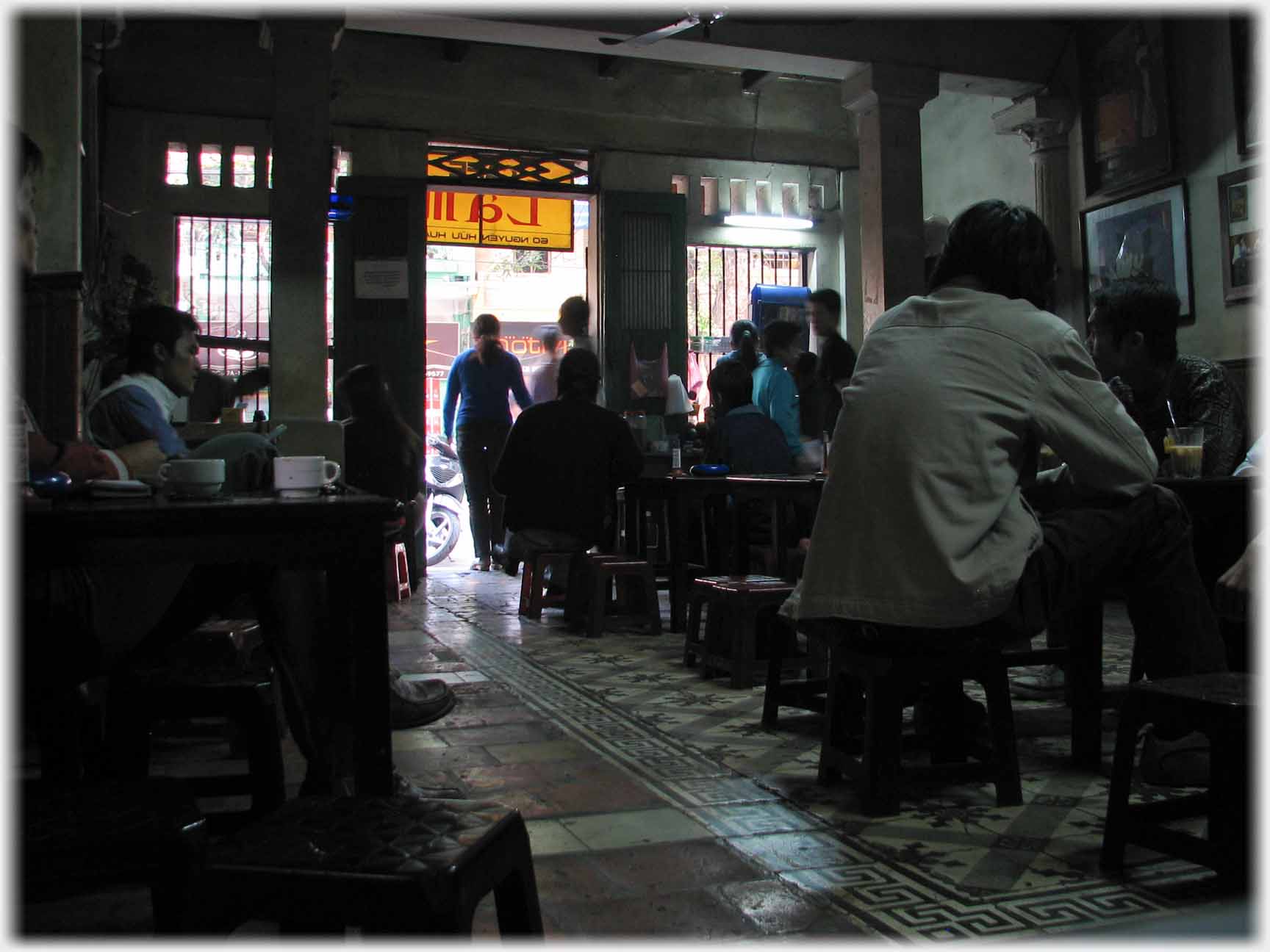 The dark interior of a cafe.