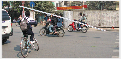 Driver and pillion holding 5 metre pipes.