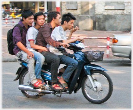 Four young men on a motorbike.