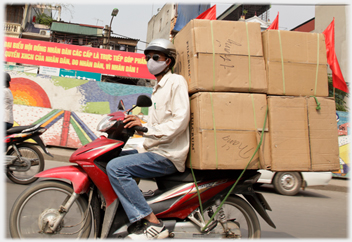 Man with four large boxes.