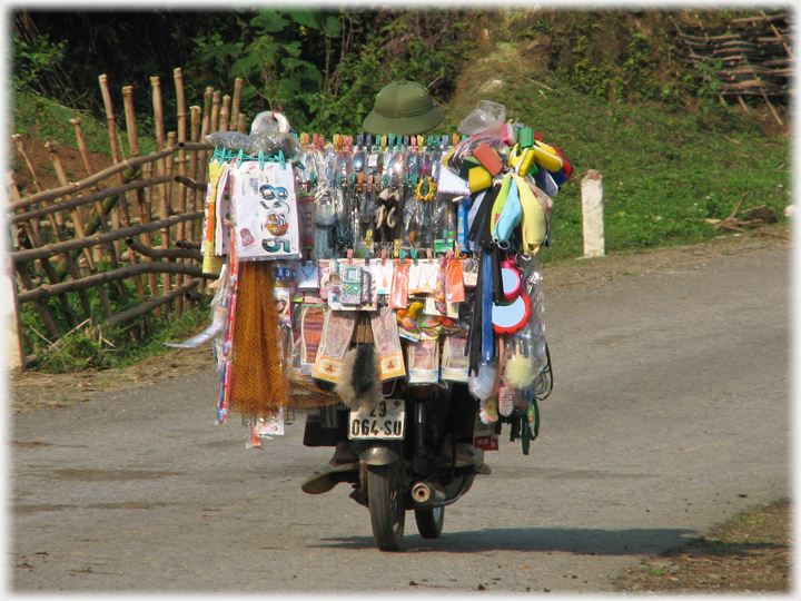 Rear view of bike with display unit covered in household items.