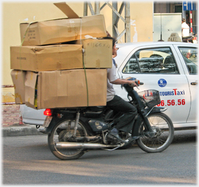 Large cardboard packages rising above the driver.