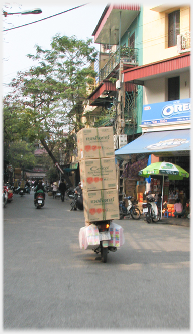 View, from rear, of three large boxes at slight angle and well covering the driver.