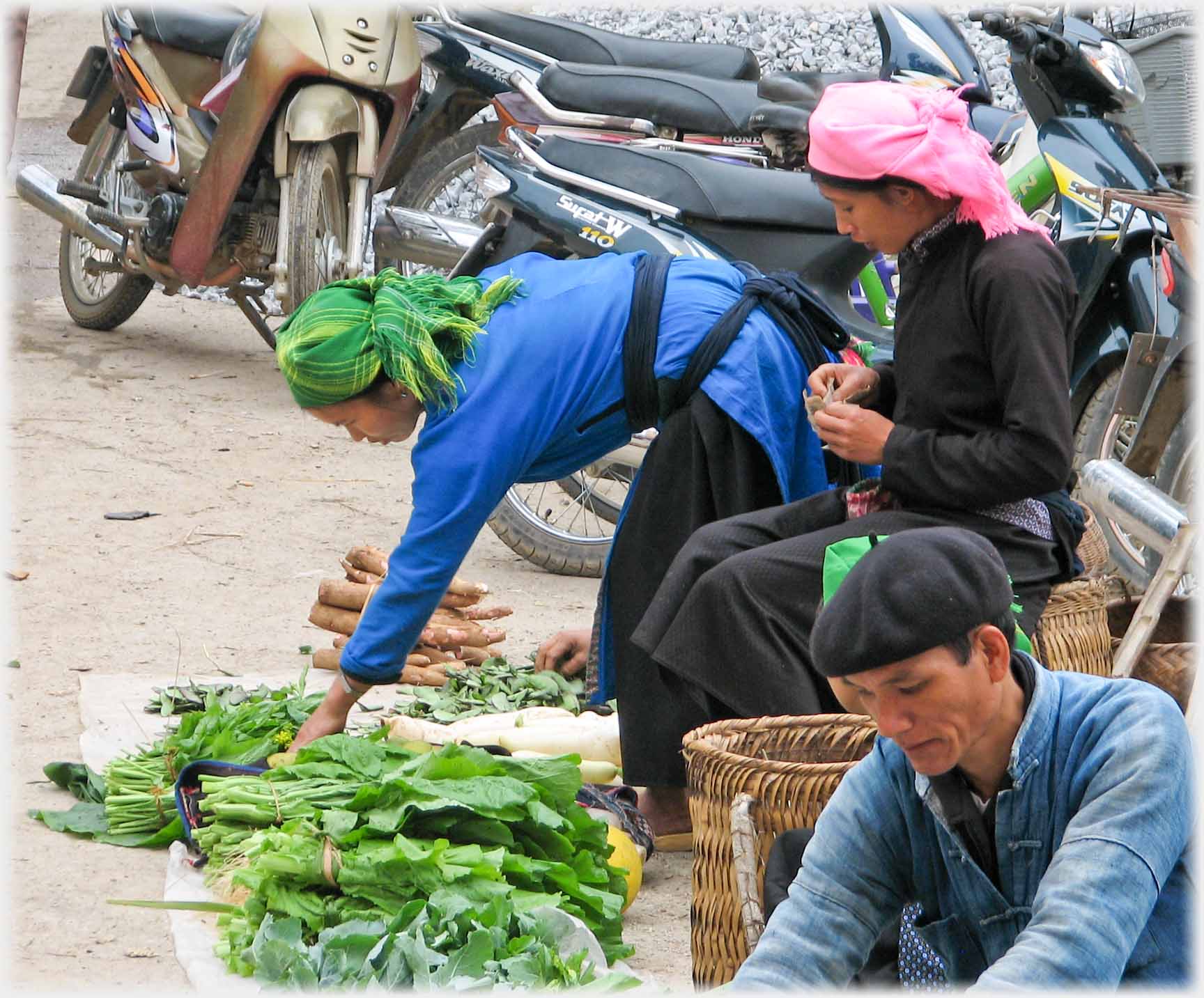 Woman bending over her produce.