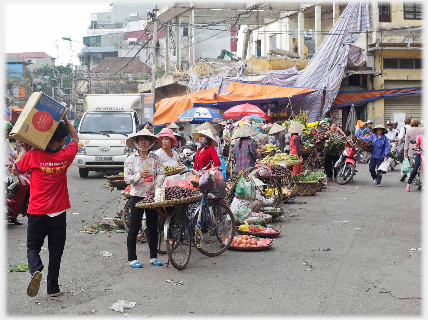 Line of sellers at a road junction in Ha Noi.