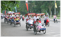 Procession of cycle rickshaws in Ha Noi.