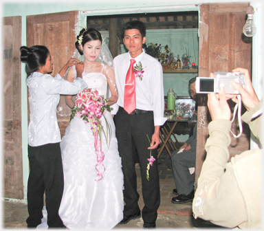 Finishing touches to bride's dress.