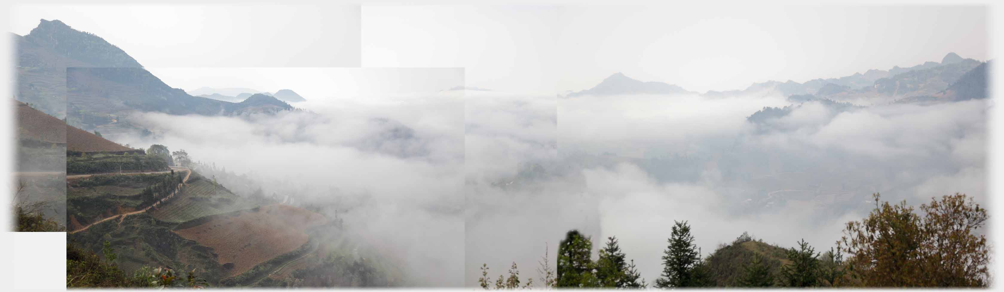 Complex of clouds with hills rising out of them.