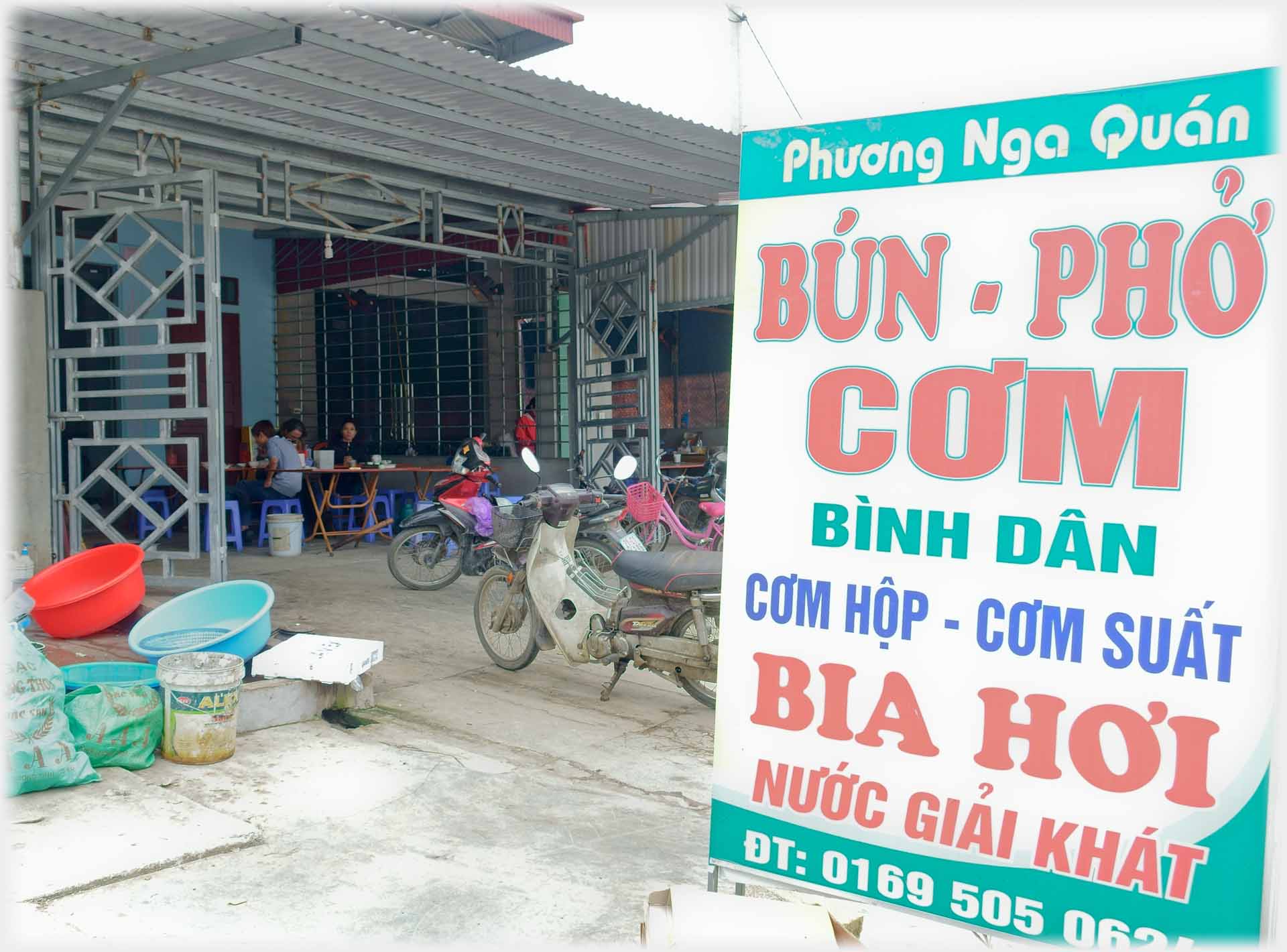 Sign in front of restaurant advertising food.