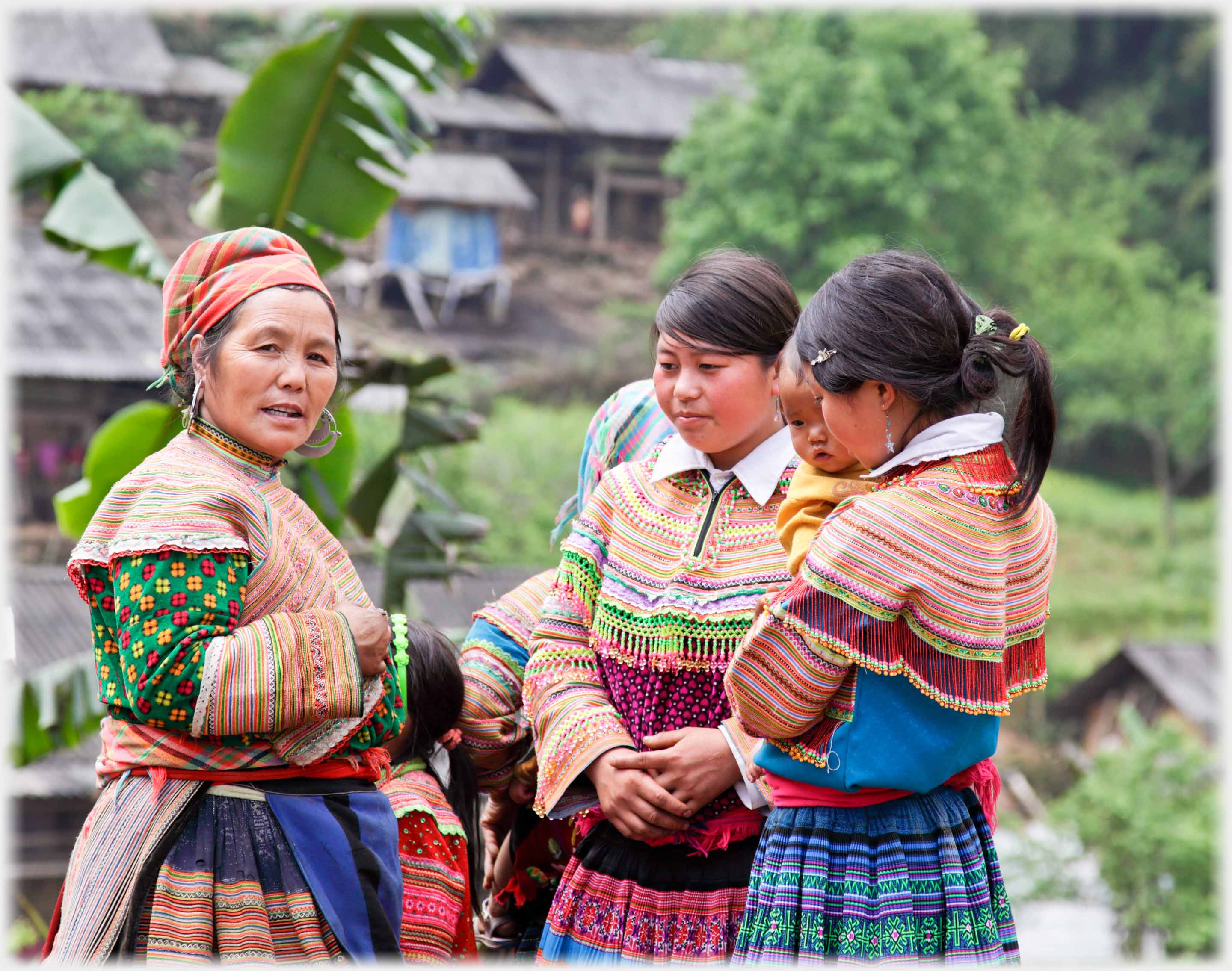 Three Hmong women, one older.