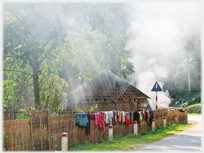 Washing being dried on a wayside fence with atmospheric smoke.