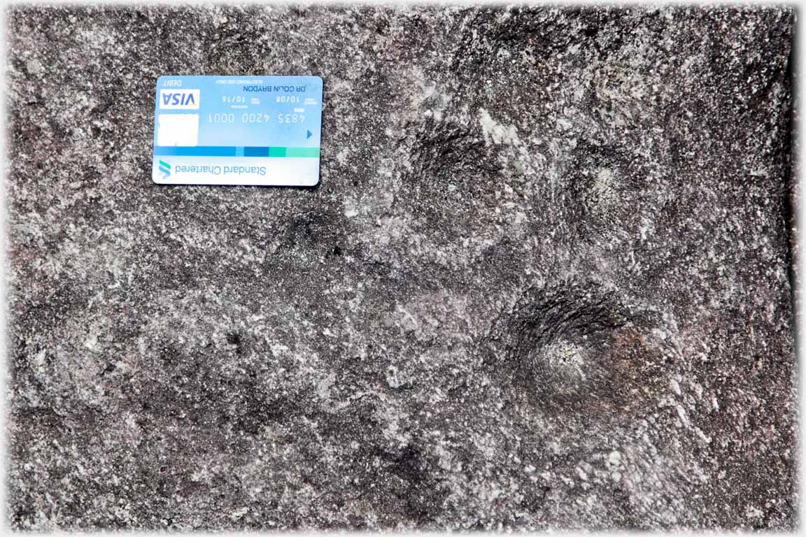 Circular marking in stone, bankers card.