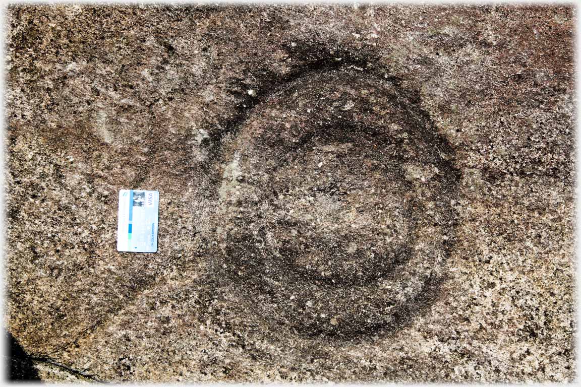 Concentric cirles in stone, bankers card.