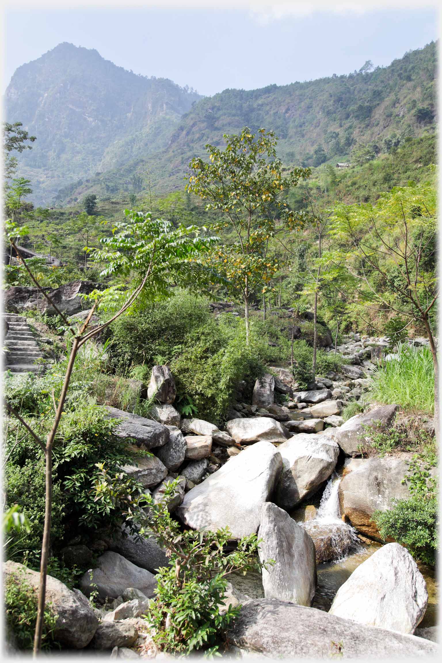 Rough rocky valley with steps just visible.