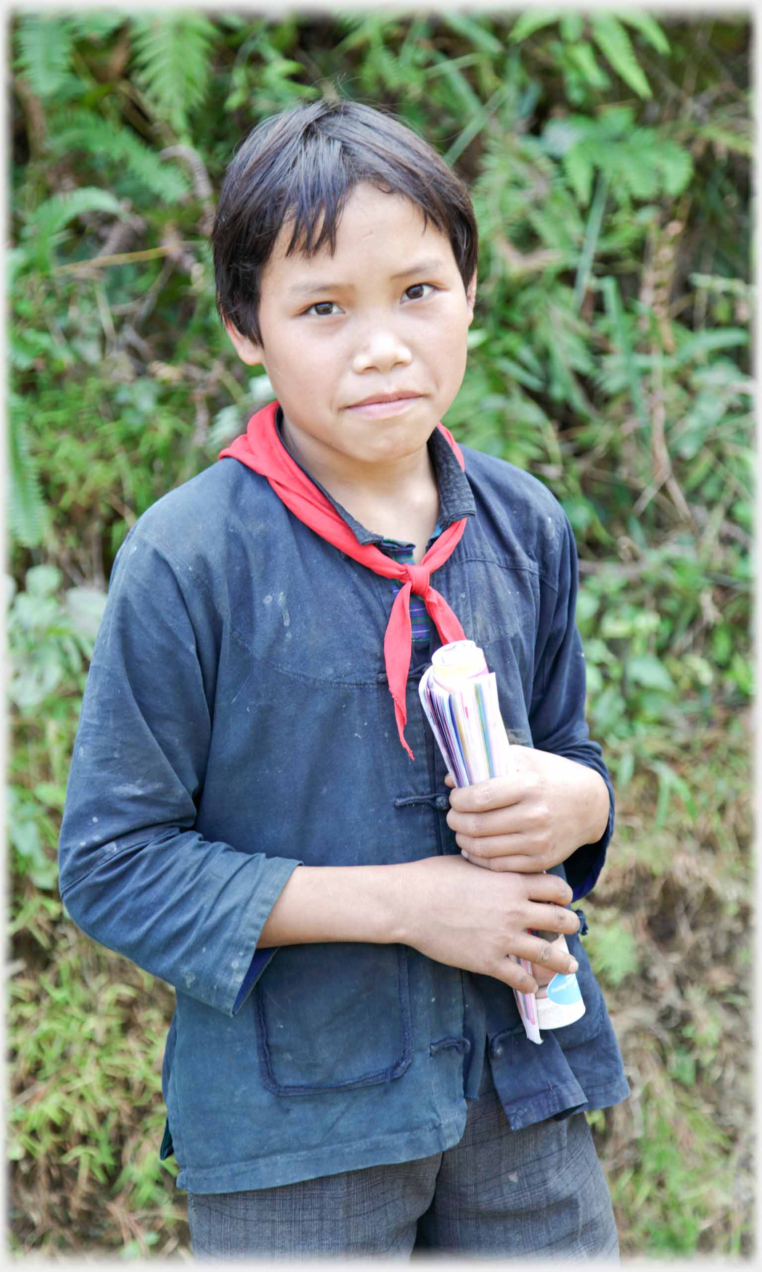 Boy with half smile looking into camera.