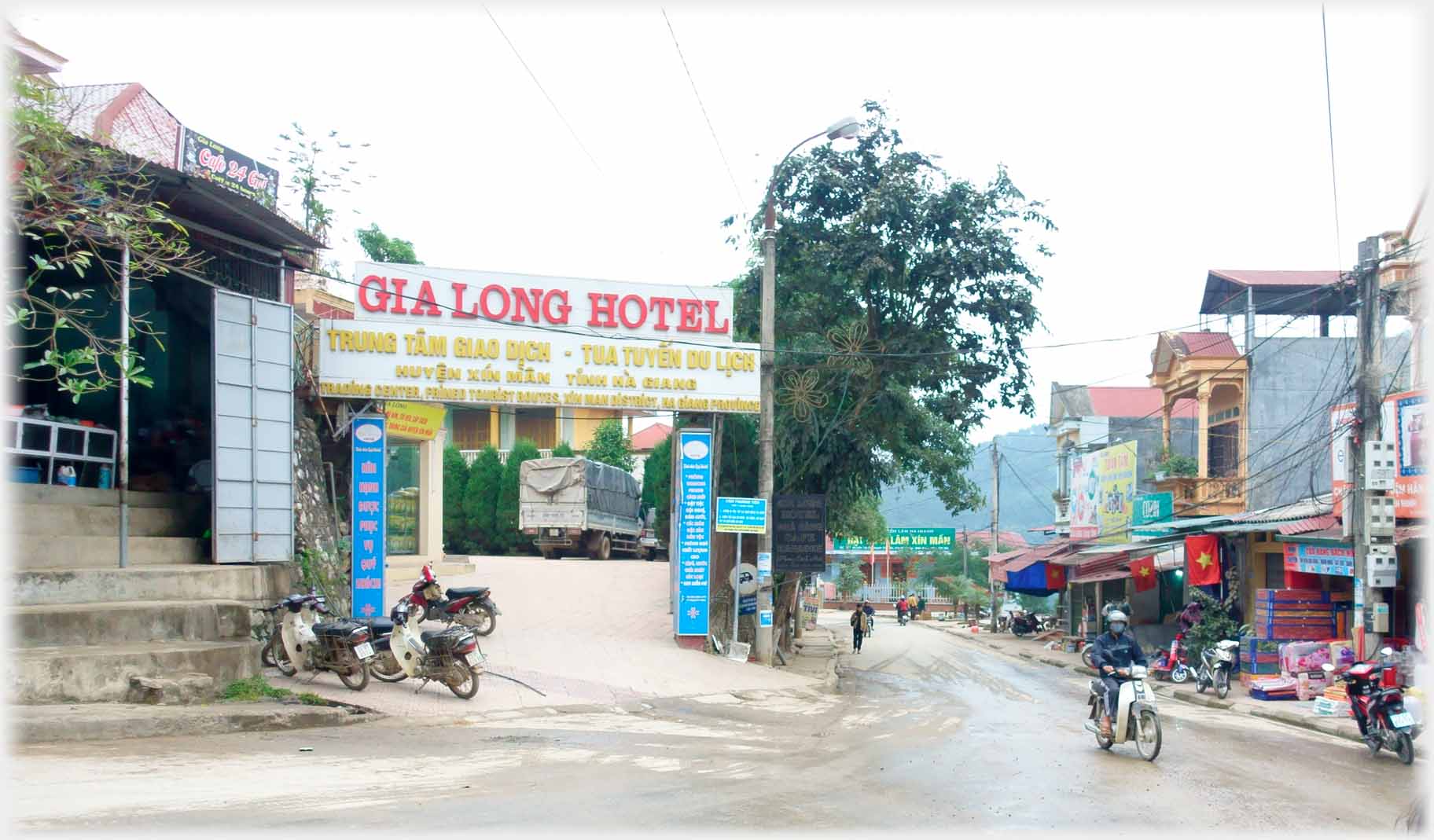 Gate entrance of hotel with sign over it.