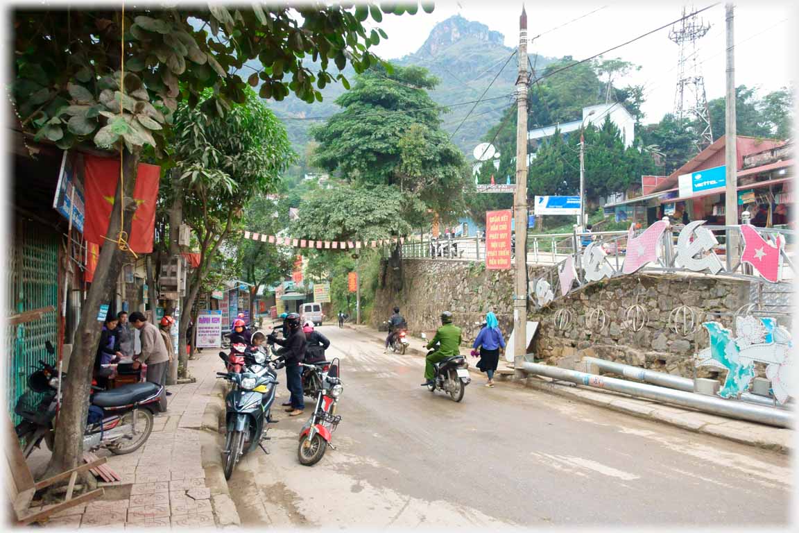 Road with motorbikes and trees.