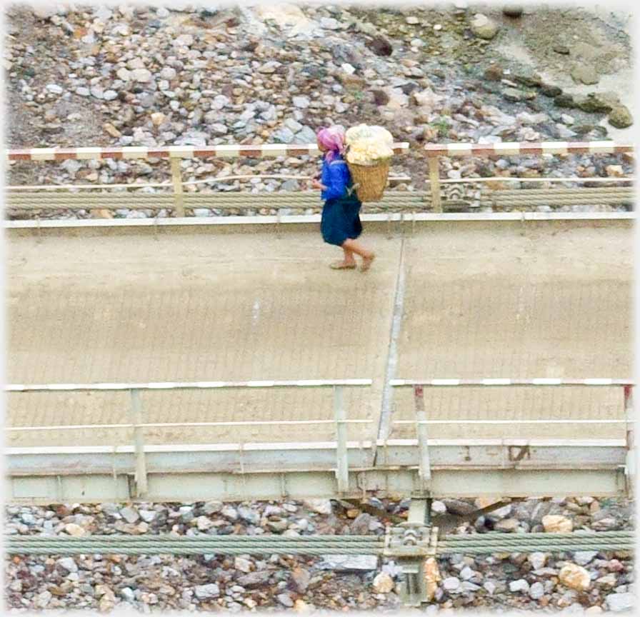 Woman with back-pack on previous bridge.