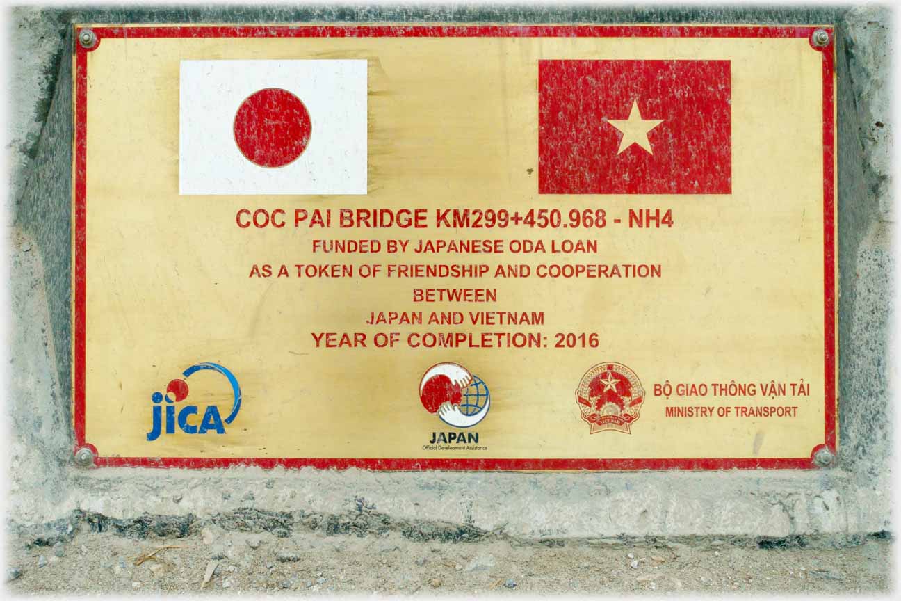 Sign in English commemorating the opening of the bridge in the nexxt photo.