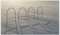 Hoops casting shadow on snow.