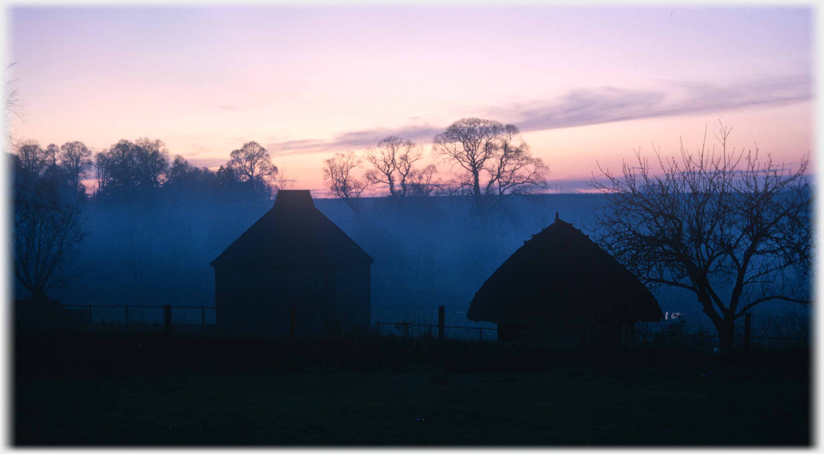Silhouette of Dove Cot sunset and mist behind.